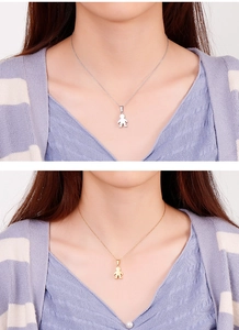Detail of silver and gold boy pendant necklaces on female model for gift ideas