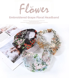 Flat lay of floral embroidered lace headbands in black, white and light blue styles
