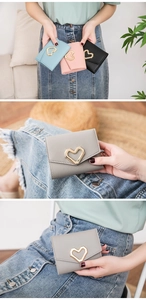 Close-up of short minimalist wallets with gold heart clasp in multiple colors