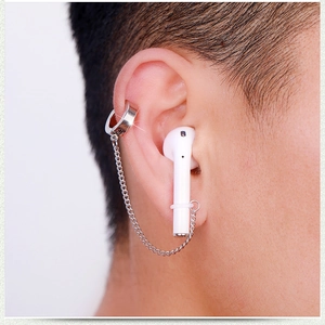 Detail view of silver anti-lost earring chain for wireless earbuds on ear