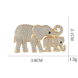 Gold elephant brooch with crystals featuring a mother and baby elephant design
