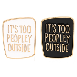Black and white enamel lapel pins featuring It's Too Peopley Outside text with gold trim