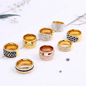 Set of eight assorted gold and silver rings with sparkling crystals on white background