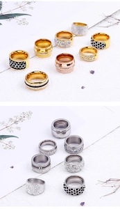 Detail of multi-color stainless steel rings with full crystal pavé inlay decoration