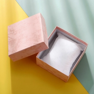 Close-up of a pink marble pattern gift box with white inner cushion for jewelry storage