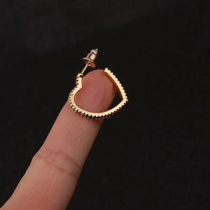 Bohemian gold heart stud earring with colorful rainbow zircons shown on ear