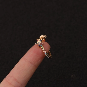 Detailed view of a gold-plated star earring with inlaid multi-colored zircon stones