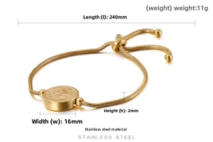 Close-up of golden stainless steel St. Benedict medal on adjustable snake chain bracelet