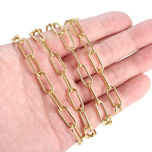 Close-up of 7mm gold paperclip chain for DIY jewelry making on human hand detail