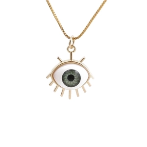 Golden necklace with green evil eye pendant in a minimalist Bohemian jewelry style