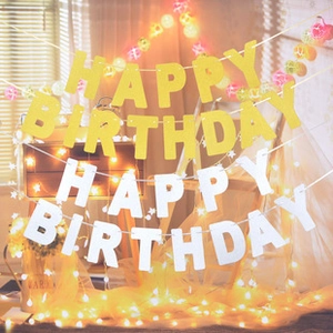 Detail of gold glitter and white matte Happy Birthday triangle banner party decorations