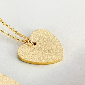 Minimalist gold heart pendant necklace with frosted finish on a classic O-link chain