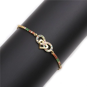 Infinity heart bracelet with colorful zircons on a black display stand