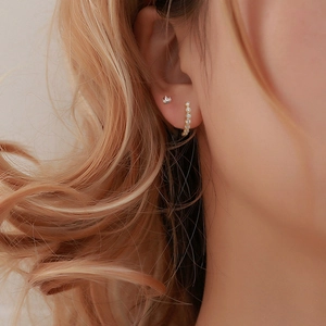 S925 silver marquise diamond crown and hoop earrings worn by a model in warm light