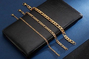 Detailed close-up of three gold titanium steel NK link bracelets in various thicknesses