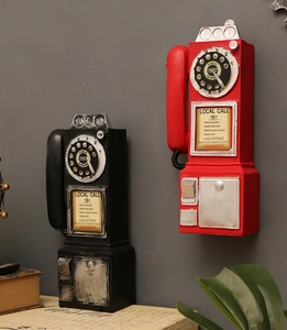 Close-up of vintage resin wall phone model with distressed finish and classic dial details