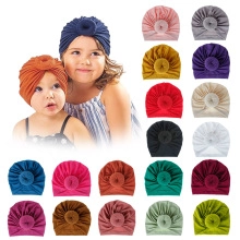 Flat lay display of 18 colorful floral fabric baby headbands and toddler hair accessories