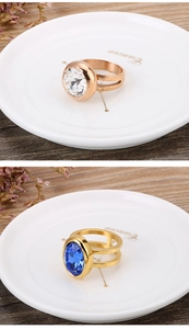 Detail of rose gold and gold stainless steel rings with large faceted crystal stones