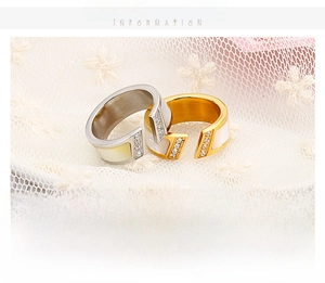Detailed close-up of 18k gold plated shell ring with crystals on lace background