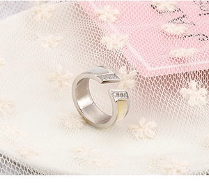 Detailed macro view of silver open ring with pavé diamonds and white shell inlay