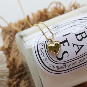 Detail of 18K gold plated heart pendant with beaded edges on a delicate ball chain