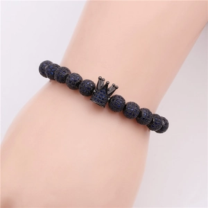 Detail of blue micro-pave zircon crown bracelet on wrist with adjustable beads