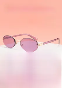 Detail view of oval rimless sunglasses with purple lenses and gold metal nose bridge