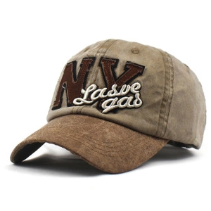 Detailed close-up of khaki baseball cap with brown suede brim and NV embroidery