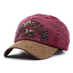 Detail of embroidered Brooklyn 35 camouflage patch on burgundy and brown baseball cap