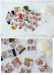 Detail showing various colors of transparent socks with cute cat patterns and fabric texture
