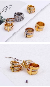 Close-up of triple-layered 18k gold and silver rings with cubic zirconia inlay details