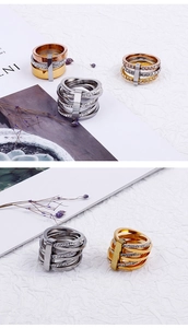 Detailed close-up of triple-layered stainless steel rings in gold, silver, and rose gold