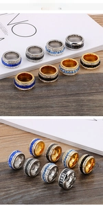 Close-up of wide stainless steel rings with 18k gold plating and colorful zircon stones