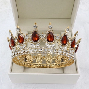 Detail view of Baroque gold bridal crown with red water drop gems in a jewelry box