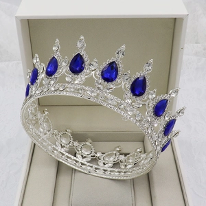 Detailed shot of silver bridal crown with blue teardrop gems in a jewelry box
