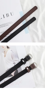 Detail of silver D-shape buckle and stitching on black and brown slim leather belts