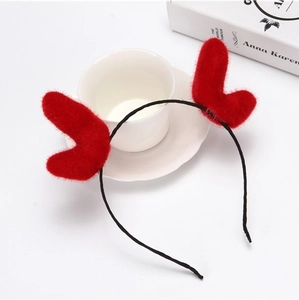 Christmas plush reindeer antler headband in vibrant red on a stylish lifestyle background