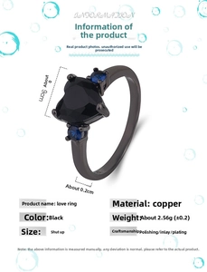 Macro view of black heart ring showing copper material specs and side blue stones