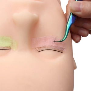 Eyelash extension grafting process with professional tweezers and breathable medical tape