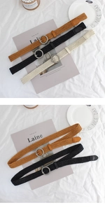 Detail view of woven wax rope belts with round metal buckles in brown, black, and beige colors