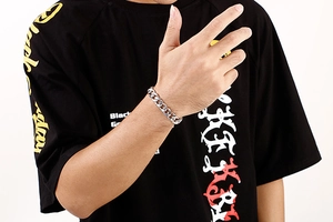 Classic silver Cuban link bracelet in stainless steel shown on a model's wrist