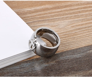 Detail of nautical anchor relief with sparkling zircon on a polished stainless steel ring