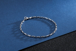 Close-up of polished stainless steel rectangular link chain bracelet with lobster clasp