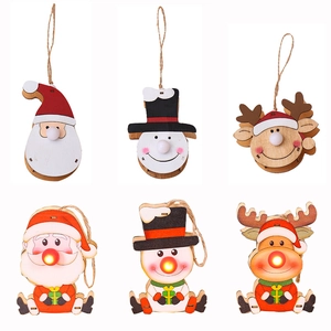 Light-up wooden Christmas tree ornaments featuring Santa Claus, snowman, and reindeer
