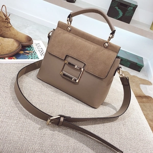 Detail of khaki frosted leather crossbody bag featuring gold metal buckle and wide strap