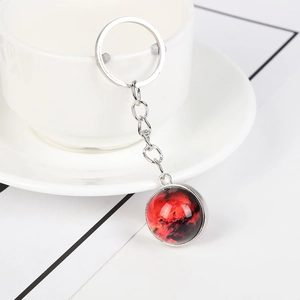 Solar system keychain with double-sided glass planet ball on a ceramic cup