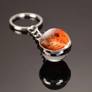 Macro shot of Mars nebula glass ball keychain with silver metal base and keyring