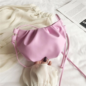 Detail of pink ruched cloud bag showing the soft PU leather texture and pleat design