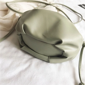 Detailed texture of the sage green pleated cloud bag in soft faux leather material