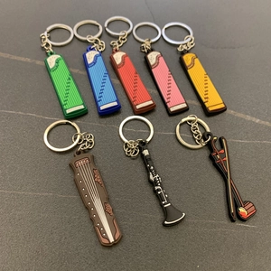 Detail view of colorful PVC musical instrument keychains including guzheng and pipa